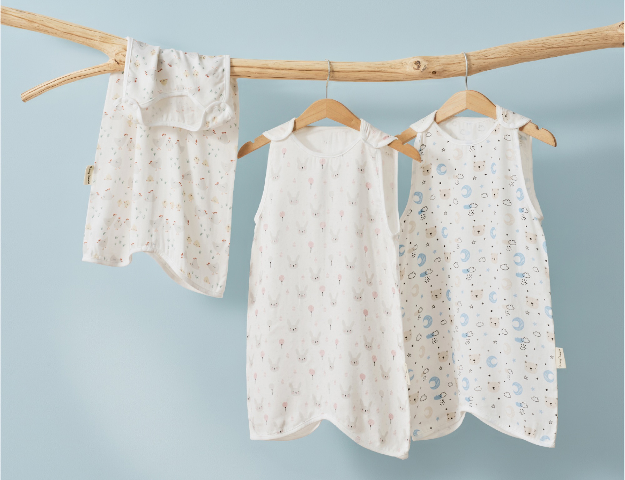 ABS kids textiles — soft printed sleep sacks hanging on a branch