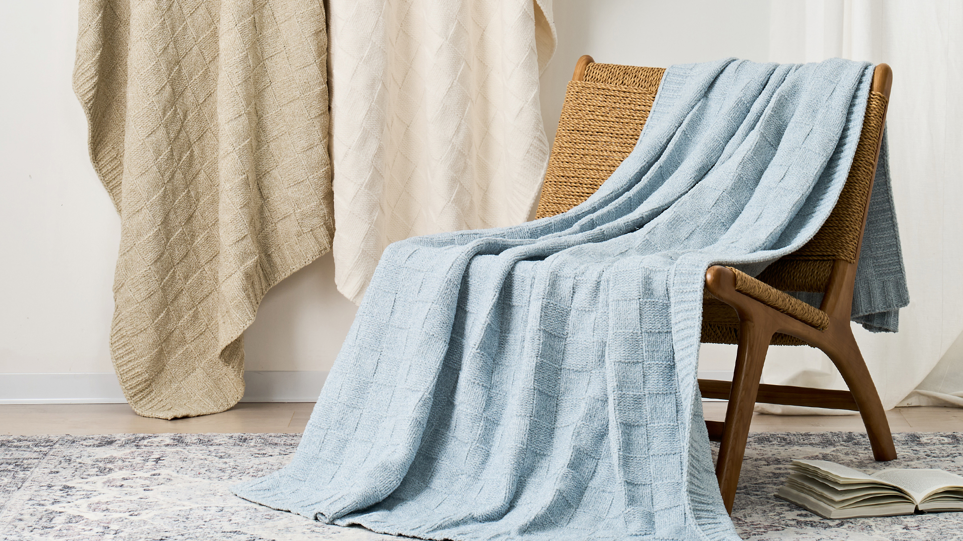 ABS throw blanket — powder-blue waffle-knit throw draped over a chair